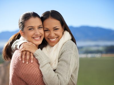 Friedship that will last. Two young female friends standing happily in the outdoors.